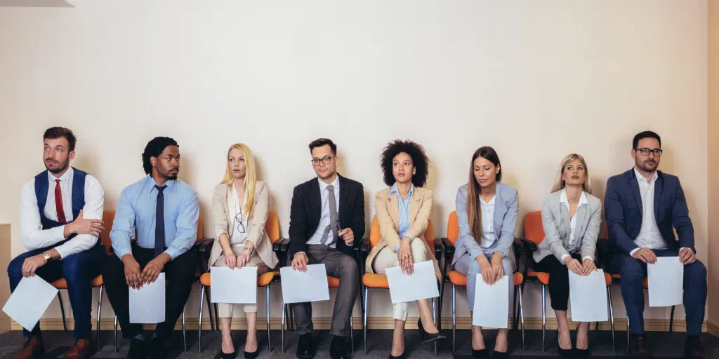 Eight candidates waiting on chairs for an interview 